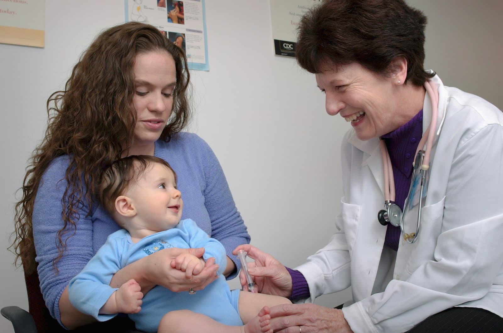 A pediatrician caring for an infant during a visit